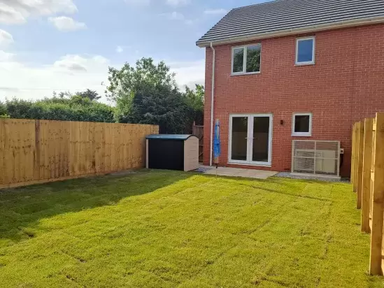 Lawned back garden of new homes in North Devon