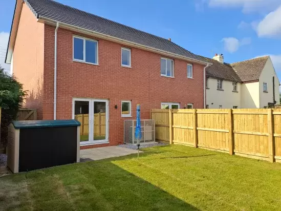 Lawned back garden of new homes in North Devon