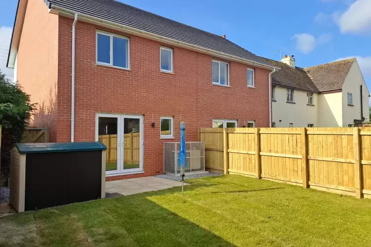 Lawned back garden of new homes in North Devon