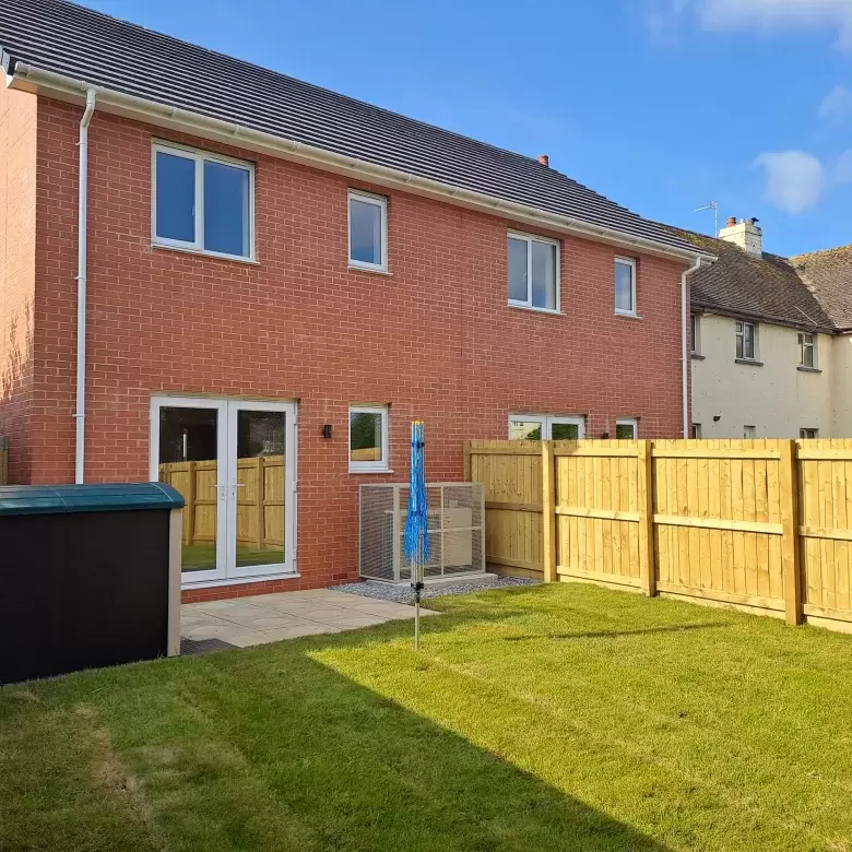 Lawned back garden of new homes in North Devon